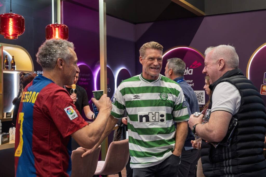 candid booth conversation captured at gaming conference