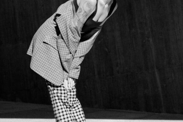 model posing in front of modern structure model posing in front of modern structure