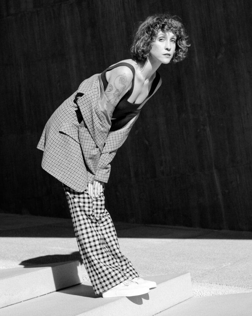 model posing in front of modern structure