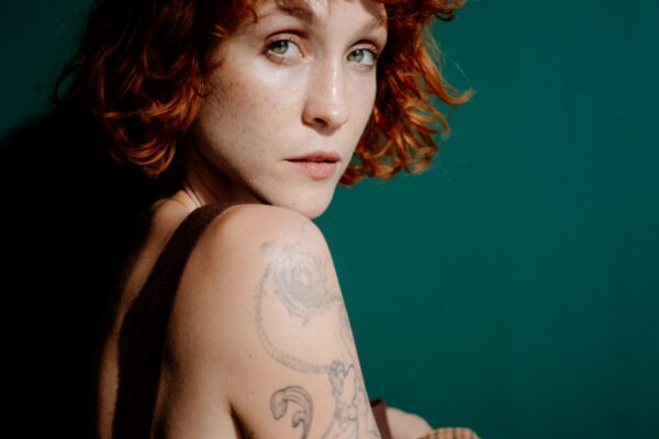 A tattoed model with red hair