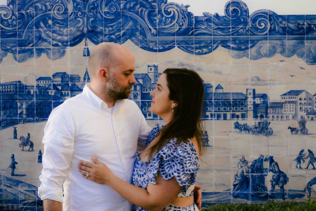 Couple photography of couple looking lovingly at each other with blue tiles in background