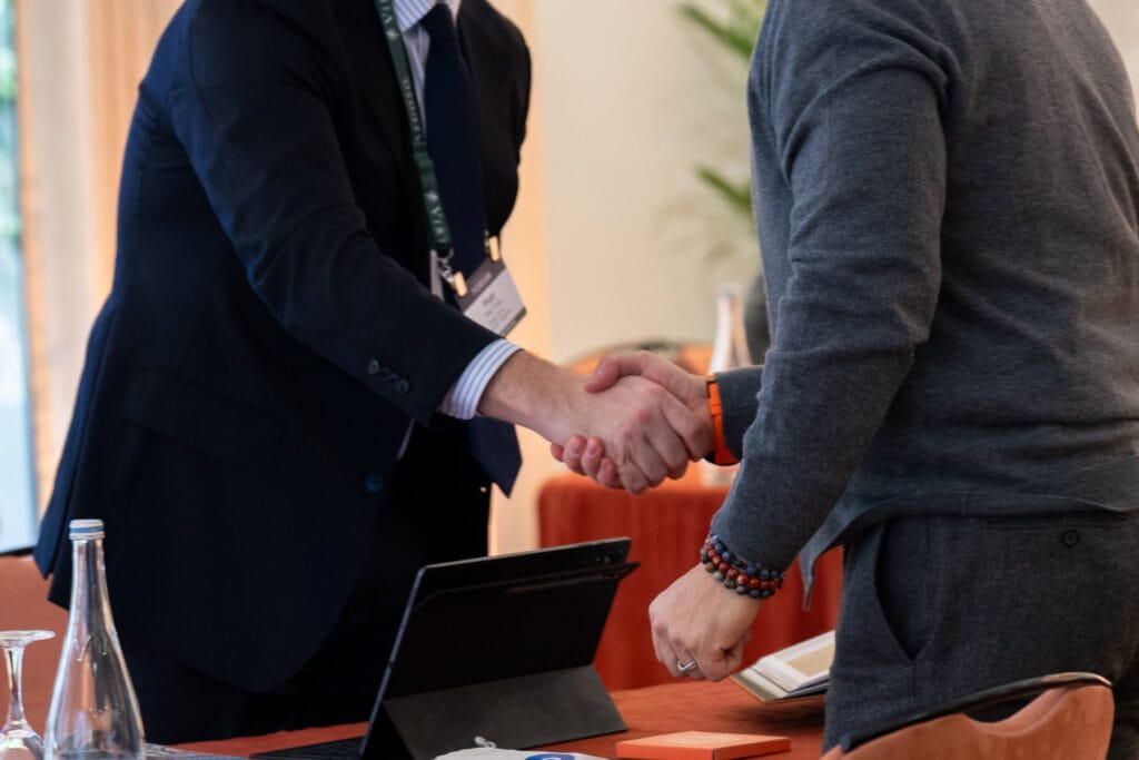 Real handshakes at networking event candid photography 